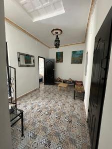 a living room with a tile floor at Hostel Tanger Medina in Tangier +39 photos