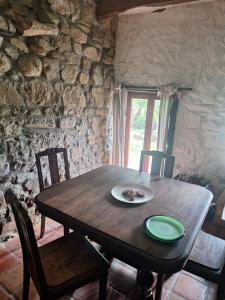 a wooden table with a plate on top of it at gite Chèvre in La Chavière +3 photos