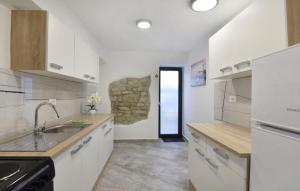 a kitchen with a sink and a counter top at Comfortable vacation retreat with parking in Plovanija