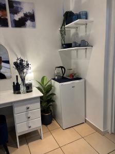 a room with a desk and a refrigerator and a table at Cottage in Ballito in Ballito