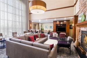 a living room with couches and a fireplace at Staybridge Suites Augusta by IHG in Augusta