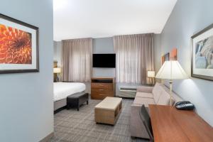 a hotel room with a bed and a living room at Staybridge Suites Augusta by IHG in Augusta +45 photos