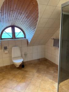 a bathroom with a toilet and a window at Villa Valdemar in Hammenhög