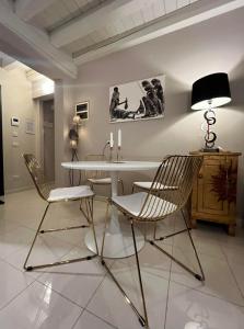 a dining room with a white table and chairs at Villa Giotto Luxury Suite & Apartments in Mestre