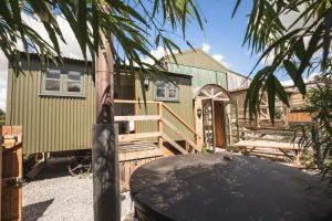 a green house with a surfboard in front of it at Willows in Rosedale Abbey
