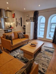 a living room with a couch and a table at 8 Mill Wharf in Berwick-Upon-Tweed