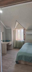 a bedroom with a bed and a window and a desk at Sweet Home in Yengidzha +22 photos