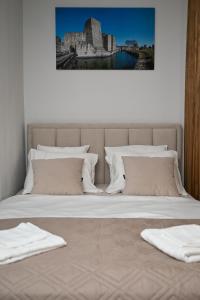 a bed with two white towels on top of it at Ana Central Studio in Smederevo
