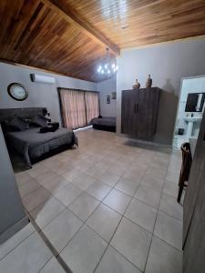 a large room with a bed and a couch at 14a on Middle Way in Tzaneen