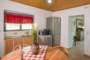 a kitchen with a table with a vase on it at Archontiko Haris in Kolymvari