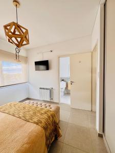a bedroom with a large bed and a television at Los Pirineos TC in Junín