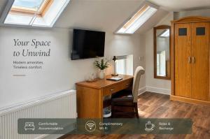 a home office with a desk and a tv on the wall at Henehan's Town House in Westport