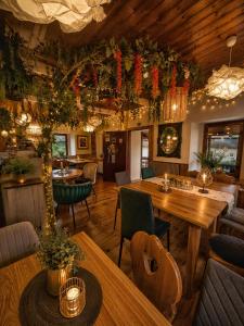 a restaurant with a table and chairs and plants at hostinec Thérése in Petrovice