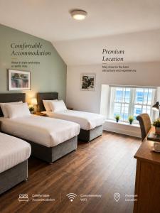 a hotel room with two beds and a sign at Henehan's Town House in Westport