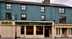 a large blue building with a street light in front of it at Henehan's Town House in Westport