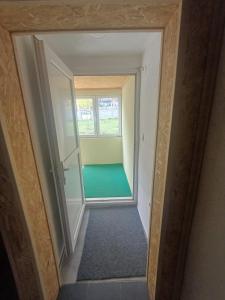 a view of a hallway with a room with a window at Montenegro Mountain Retreat in Podgorica