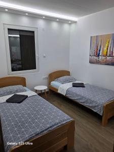 a room with two beds and a window at Serbian home - free parking - Bazen se doplaćuje in Krnjača +47 photos