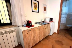 a small kitchen with a sink and a microwave at Your Charming Amantea Getaway in Amantea +5 photos