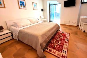 a bedroom with a bed and a rug at Your Charming Amantea Getaway in Amantea