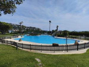 a large swimming pool in a park with a fence at Vitamin Sea in Zahara de los Atunes