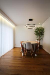 a dining room with a table and a potted plant at Private Beach Villa in Vila Nova de Gaia
