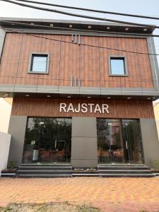 a building with a raisin star sign on it at Rajstar Resort in Murthal