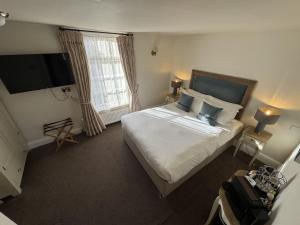 a bedroom with a large bed and a large window at The Old Fourpenny Shop Hotel in Warwick +57 photos