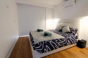a bedroom with a large bed in a white room at Private Beach Villa in Vila Nova de Gaia +39 photos