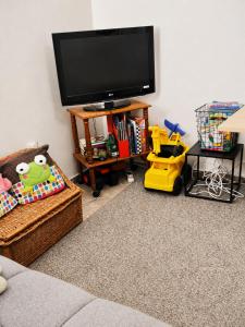 a living room with a flat screen tv and toys at Pinetree House in Nafplio