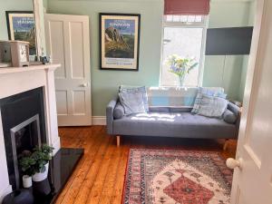 a living room with a couch and a fireplace at Lough View in Rostrevor