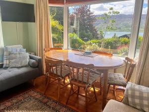 a dining room with a table and a large window at Lough View in Rostrevor