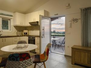 a kitchen with a table and chairs and a table at Sea & Olive Retreat in Zipárion