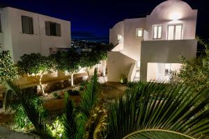 a large white building with trees in front of it at Stay Lux Suites in Karterados