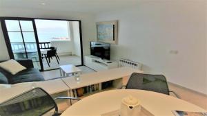 a living room with a table and chairs at Apartamento Aqua by VACAY L'Escala in L'Escala