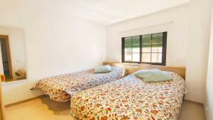 a bedroom with two beds and a window at Apartamento Aqua by VACAY L'Escala in L'Escala +25 photos