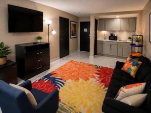 a living room with a couch and a kitchen at Super 8 by Wyndham Lexington Park/California Area in California