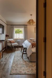 a bedroom with a bed and a desk and a window at The General Tarleton in Knaresborough