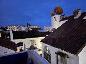 a view of roofs of buildings with a basketball at Casa Feliz in Torrox Costa