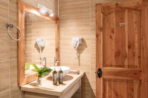 a bathroom with a sink and a mirror at Rapa Nui, La Residence in Hanga Roa +49 photos