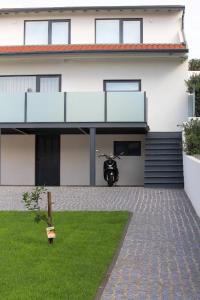 a house with a motorcycle parked in front of it at Private Beach Villa in Vila Nova de Gaia
