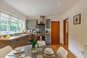 a kitchen with a table and chairs in a kitchen at 2 Bed in Godshill oc-78573 in Godshill +16 photos