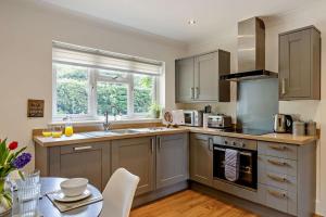 a kitchen with stainless steel appliances and a table at 2 Bed in Godshill oc-78573 in Godshill