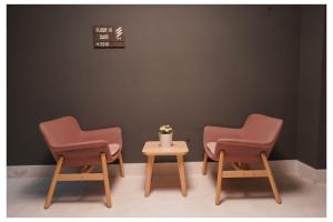 two chairs and a table in a waiting room at Saray Prime Suites in Kuwait