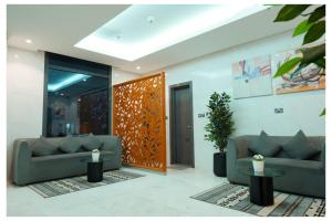 a living room with two couches and a table at Saray Prime Suites in Kuwait