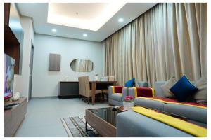 a living room with couches and a dining room at Saray Prime Suites in Kuwait +31 photos