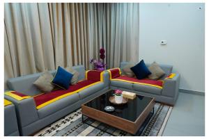 a living room with a couch and a coffee table at Saray Prime Suites in Kuwait