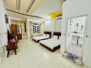 a large room with two beds and a fireplace at Ngoc May Guesthouse in Chau Doc +26 photos