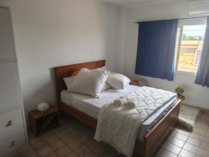 a bedroom with a bed with two towels on it at 'Belkaz in Port-Gentil +11 photos