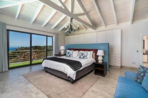 a bedroom with a bed and a view of the ocean at KNYSNA Breakwaters Haven in Knysna +84 photos