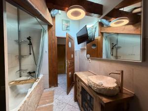 a bathroom with a sink and a mirror at La maison d'Artzamendi in Louhossoa +19 photos